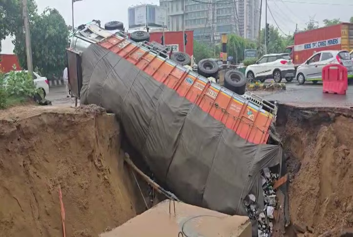 Gurugram's Shocking Collapse: Truck Plunges Into Massive Sinkhole! Gurugram road collapse, heavy rainfall impact, truck accident rescue
